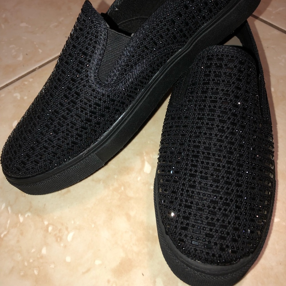 Slip on black sneakers with crystals.